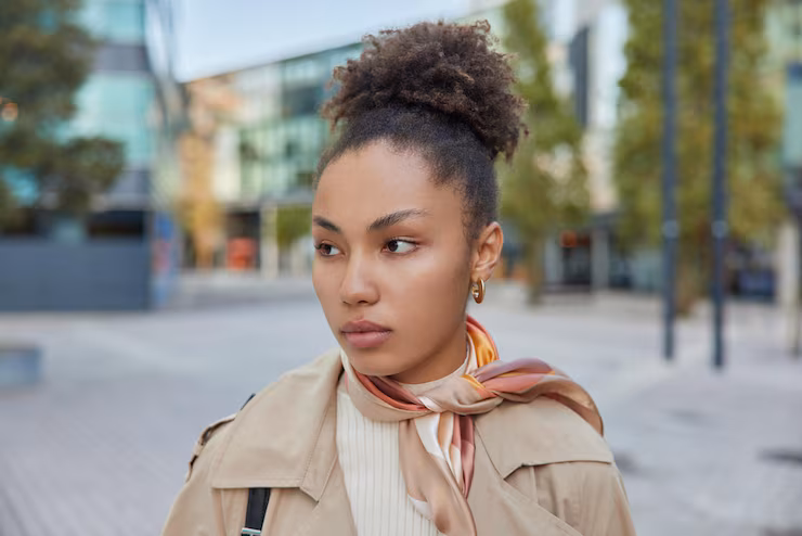thoughtful-woman-with-curly-combed-hair-wears-coat-kerchief-tied-neck-concentrated-away-poses-against-blurred-street-background-pretty-female-model-explores-new-city-pastime_273609-60615